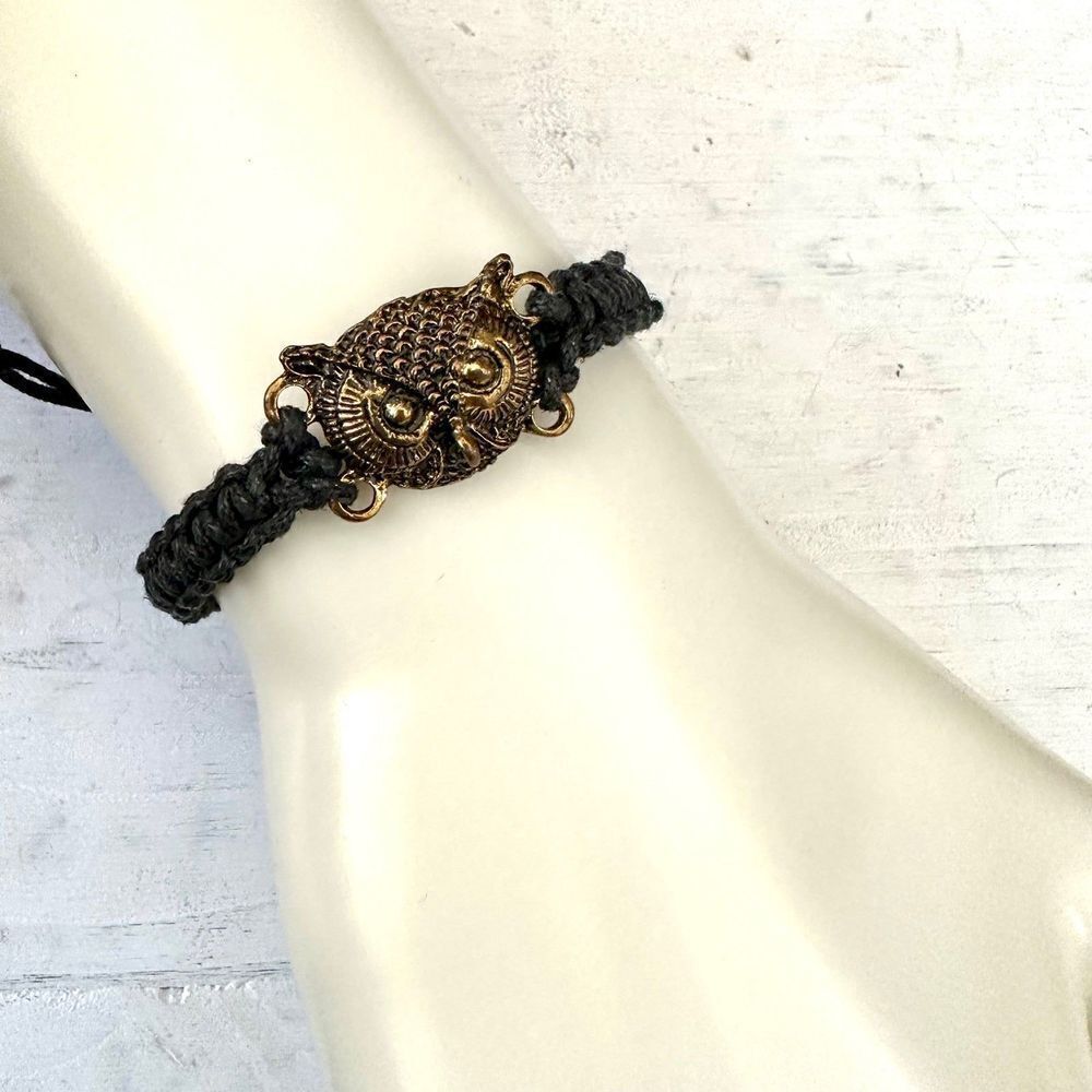 Gold tone owl black cord bracelet